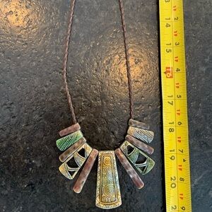 No name boho light in weight necklace. Leather rope and silver tone clasp.
